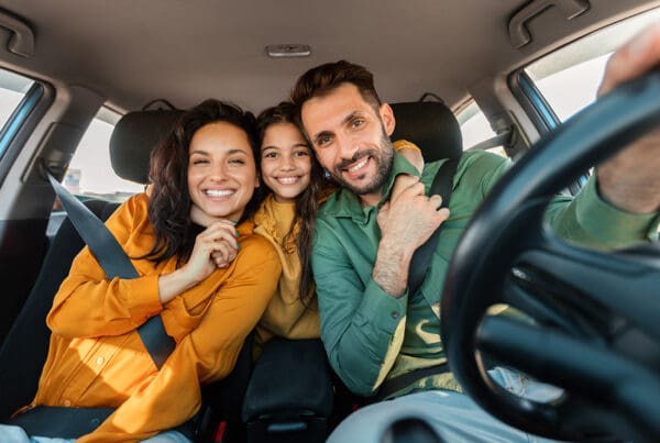 Car Insurance for Dummies – Quincy, WA - Excited Family Embracing Sitting in New Car Driving and Enjoying Road Trip on Vacation